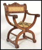 A early 20th century carved oak / beech wood Savonarola throne chair having shaped base with