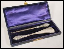 A group of silver hallmarked dressing table items to include shoe horn, button hooks, brush along