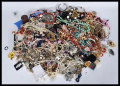 A large collection of vintage costume jewellery to include a 50's lighter with simulation pearl
