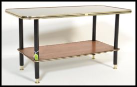 A 1950's glass coffee table with a backgammon pattern with attached teak wood lower tier to the base