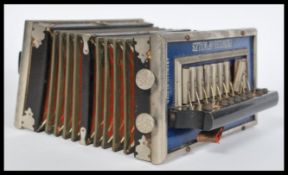 A vintage 20th century Princess of Wales button accordion squeezebox with royalty print bellows with