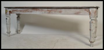A 20th century shabby chic long refectory painted dining / skullery table. Raised on turned legs