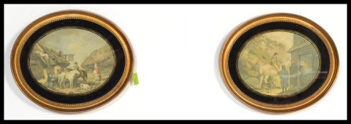 A pair of gilt oval frames with beading detailing and a black and gilt slip and hanging rings to the