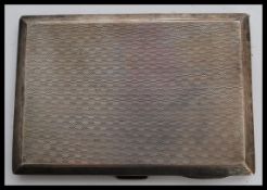 A hallmarked silver early 20th century cigarette case having an engine turned checkered design.