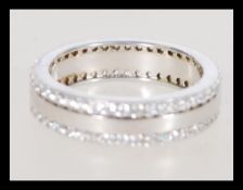 A 20th century silver eternity ring with inset cubic zirconia weighing 5.9 grams, size U.