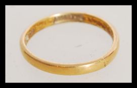 A 18ct gold hallmarked ladies wedding band weighing 2.3 grams.