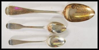 A group of three Georgian silver hallmarked spoons to include two tea spoons and one large table