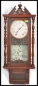 A vintage 20th century Vienna regulator wall clock having turned columns and arched pediment top.