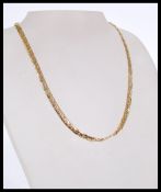 A gold flat chain necklace with a lobster clasp 17 icnhes in length and 23.2 grams in weight.