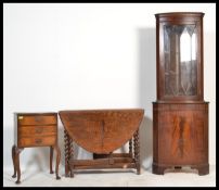 A collection of furniture to include an oak drop leaf dining table raised on barley twist