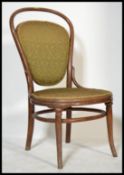 An early 20th Century Thonet bentwood nursing chair, upholstered seat pad and backrest raised on