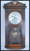An 20th century rectangular oak cased wall clock with Arabic numerals and faceted hands having an