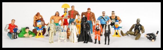 A group of vintage action figures to include Star Wars Darth Vader, C3PO, R2D2, Princess Leia,