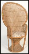 A vintage 20th century cane wicker rattan weave conservatory chair, having a peacock fan back with