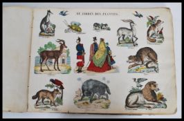 A vintage early 20th century French scrap album containing carious coloured cutouts, comic