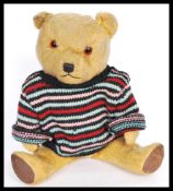 A 1950's mid 20th century vintage teddy bear made from mohair with red and black resin eyes,