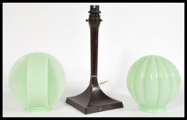 A vintage early 20th century Bakelite Art Deco lamp on a square base with two circular mint green
