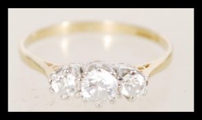 A hallmarked 9ct gold ring having three white stones set into white gold decorative prong