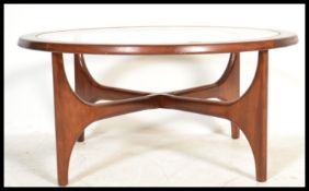 A 1970's G-Plan Atomic style coffee table of circular form raised on space age style supports with 4