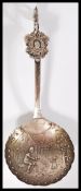 A rare early 20th century silver hallmarked London import silver caddy spoon with Dutch scenes and