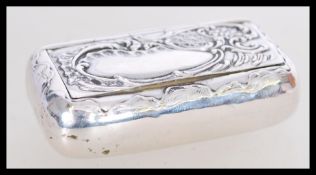 A 19th century Victorian silver snuff box having an embossed floral decoration to the lid with plain