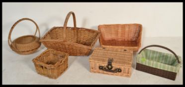 A group of vintage wicker baskets and hampers of small proportions include a bottle box with two