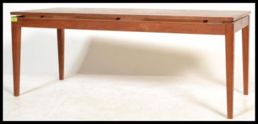 A vintage retro 20th century Danish teak wood coffee table raised on tapered supports with