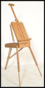 A 20th century artists collapsible easel box with three extendable legs and adjustable easel