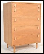 A retro 20th Century light teak wood pedestal chest of drawers, five graduating drawers raised on
