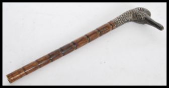 An early 19th century George III silver ladies walking stick handle in the form of a duck with glass