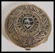 A vintage 1950's Islamic silver white metal compact having pierced decoration to the front and a