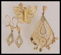 A selection of 9ct gold jewellery to include geometric drop earrings, a butterfly pendant with