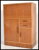 A 1930's Oak Art Deco bureau having fall front bureau with appointed interior having cupboard and