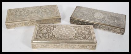 A set of three Persian Islamic silver white metal trinket boxes having embossed floral detailing