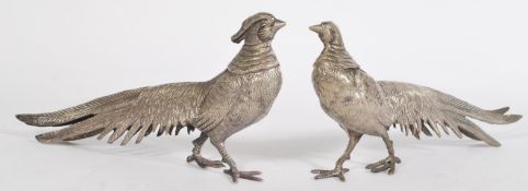 A pair of 20th century silver plated pheasant ornaments featuring a male and a female with lengthy