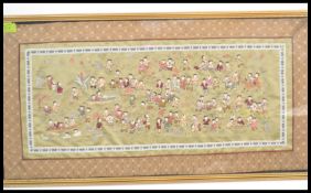 A 20th century Chinese silk hand embroidered tapestry depicting the 100 children being framed and