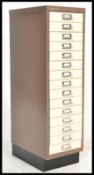 A 20th Century metal Bisley Industrial fifteen drawer index filing cabinet raised on a plinth