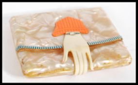 A vintage celluloid Art Deco 1920's cigarette case including a celluloid folded hand clasp with an