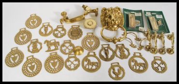 A group of vintage brass wares to include a gilt brass lion mask door knocker, door furniture and