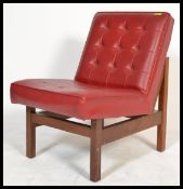 A 1970's retro vintage easy lounge chair / armchair comprising of a button backed crimson red
