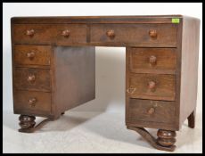 A vintage 1930's Art Deco oak twin pedestal drawer, having an arrangement of drawers with inset