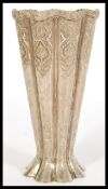 A 20th century Persian Islamic white metal silver small vase of fluted form having raised floral