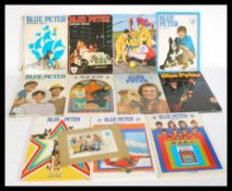 A group of vintage Blue Peter annuals to include a signed Blue Peter group photograph. Please see