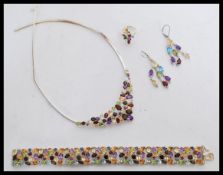 A collection of white metal and multicoloured rhinestone jewellery to include a split band ring with