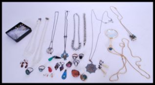 A collection of costume jewellery to include a magnifying glass pendant, a collection of agate