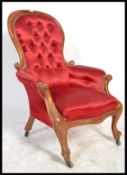 A Victorian walnut framed spoon back easy chair wi