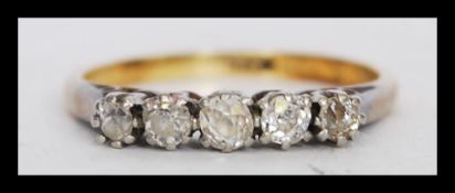 A 20th century 18ct gold ring with five old cut diamonds in prong settings. Weight 2.5 grams.