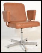 A vintage / retro 20th Century swivel chair - desk armchair being raised on a chrome adjustable