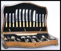 A 58 piece set of silver plated oak cased 1950's vintage cutlery canteen by Brown and Gardiner.