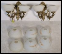 A pair of stunning gilt brass twin branch wall sconces, with  two sets of vintage milk glass